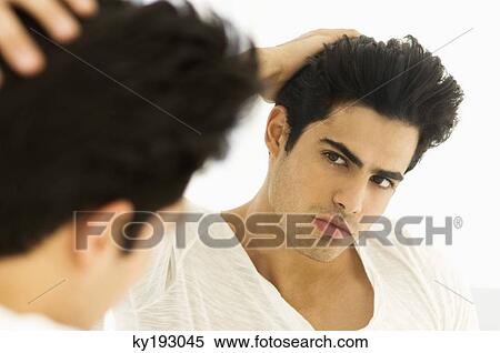 Stock Photography - Reflection of a man in the mirror. Fotosearch