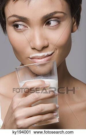 Close-up of a woman drinking milk from a glass View Large Photo Image Stock Image - Close-up of a woman drinking milk from a glass. Fotosearch