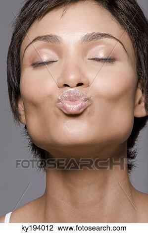 Stock Image - Close-up of a woman puckering lips. Fotosearch