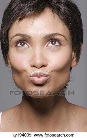 Close-up of a woman puckering lips View Large Photo Image Stock Photography - Close-up of a woman puckering lips. Fotosearch