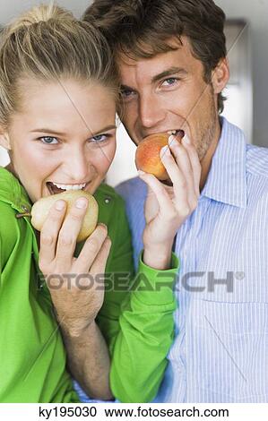 Close-up of a couple eating fruits View Large Photo Image Stock Image - Close-up of a couple eating fruits. Fotosearch