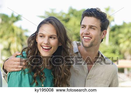 Close-up of a couple smiling View Large Photo Image Stock Photo - Close-up of a couple smiling. Fotosearch