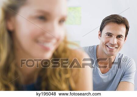 Close-up of a couple smiling View Large Photo Image Stock Photo - Close-up of a couple smiling. Fotosearch