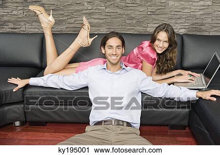 Couple in a living room View Large Photo Image Stock Image - Couple in a living room. Fotosearch