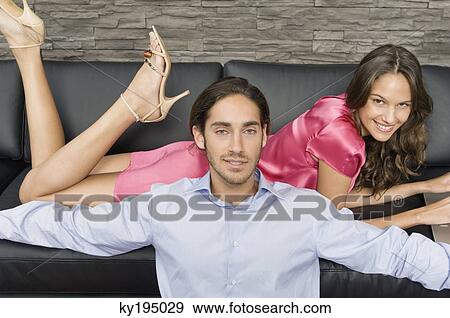 Couple in a living room View Large Photo Image Stock Photo - Couple in a living room. Fotosearch