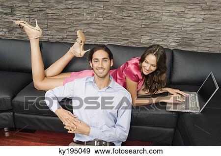 Couple in a living room View Large Photo Image Stock Photo - Couple in a living room. Fotosearch