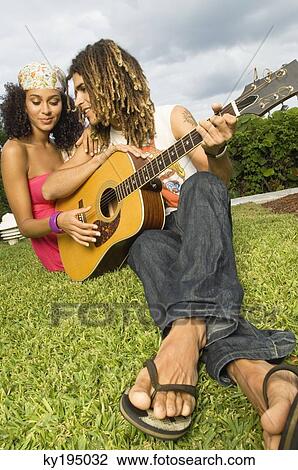 Couple playing a guitar View Large Photo Image Stock Image - Couple playing a guitar. Fotosearch