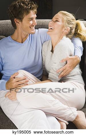 Couple romancing on a couch View Large Photo Image Stock Photography - Couple romancing on a couch. Fotosearch