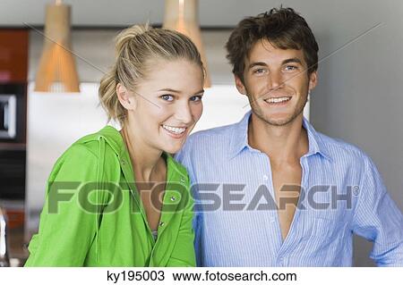 Portrait of a couple in the kitchen and smiling View Large Photo Image Stock Image - Portrait of a couple in the kitchen and smiling. Fotosearch