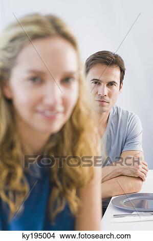 Portrait of a man and a woman sitting at a dining table View Large Photo Image Picture - Portrait of a man and a woman sitting at a dining table. Fotosearch