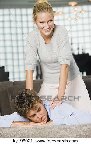 Woman massaging a man's shoulders View Large Photo Image Stock Image - Woman massaging a man's shoulders. Fotosearch