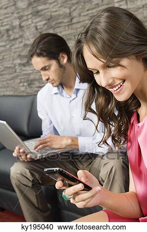 Woman reading text message on a mobile phone View Large Photo Image Stock Image - Woman reading text message on a mobile phone. Fotosearch