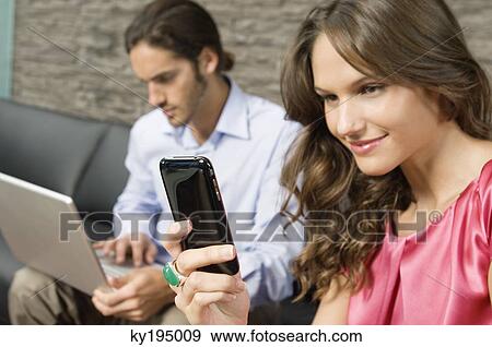Woman reading text message on a mobile phone View Large Photo Image Stock Photo - Woman reading text message on a mobile phone. Fotosearch