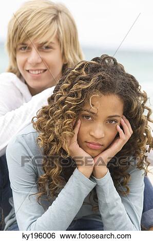 Portrait of a teenage boy with a girl on the beach View Large Photo Image Stock Photograph - Portrait of a teenage boy with a girl on the beach. Fotosearch
