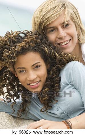 Portrait of a teenage boy with a girl on the beach View Large Photo Image Stock Photography - Portrait of a teenage boy with a girl on the beach. Fotosearch