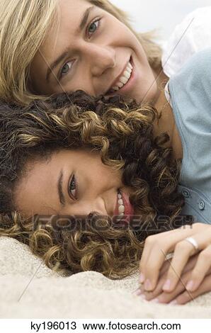 Teenage boy and a girl relaxing on the beach View Large Photo Image Stock Image - Teenage boy and a girl relaxing on the beach. Fotosearch
