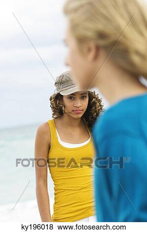 Teenage boy standing with a girl on the beach View Large Photo Image Stock Photo - Teenage boy standing with a girl on the beach. Fotosearch