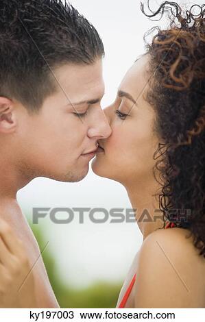 Close-up of a couple kissing each other View Large Photo Image Stock Image - Close-up of a couple kissing each other. Fotosearch