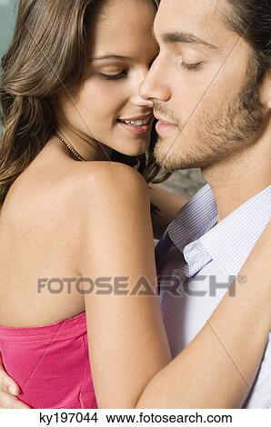 Close-up of a couple romancing View Large Photo Image Picture - Close-up of a couple romancing. Fotosearch