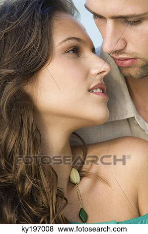 Stock Photo - Close-up of a couple romancing. Fotosearch