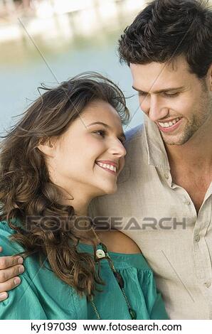 Close-up of a couple romancing View Large Photo Image Stock Photo - Close-up of a couple romancing. Fotosearch