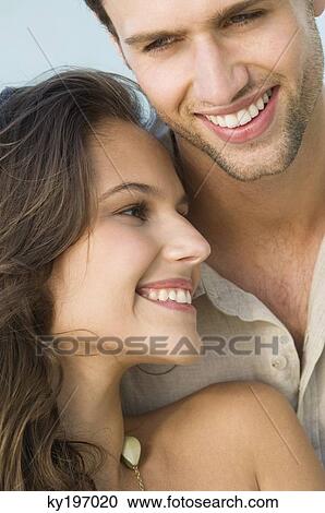 Close-up of a couple smiling View Large Photo Image Stock Image - Close-up of a couple smiling. Fotosearch
