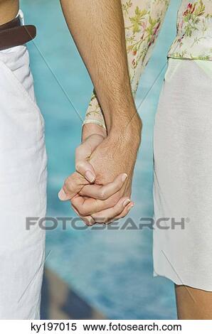 Stock Photography - Couple holding hands. Fotosearch