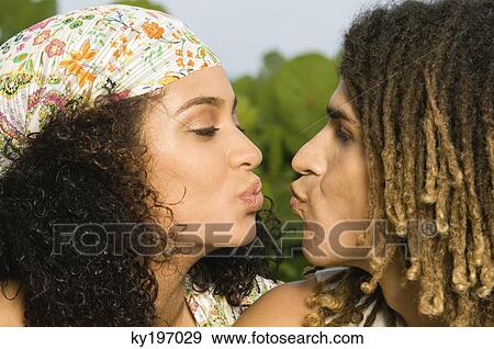 Couple preparing to kiss each other View Large Photo Image Stock Photo - Couple preparing to kiss each other. Fotosearch