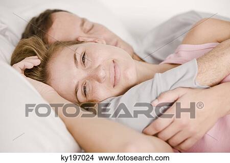 Couple sleeping on the bed View Large Photo Image Picture - Couple sleeping on the bed. Fotosearch