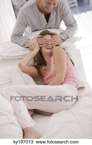 Man covering eyes of a woman from behind View Large Photo Image Stock Image - Man covering eyes of a woman from behind. Fotosearch