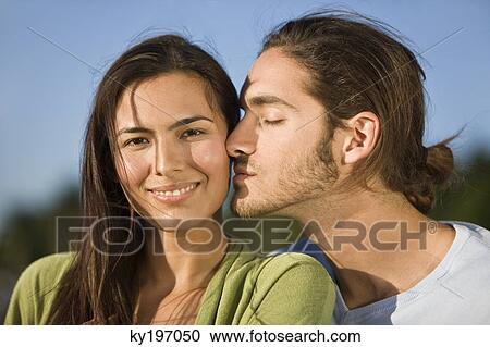 Man kissing a woman View Large Photo Image Stock Image - Man kissing a woman. Fotosearch