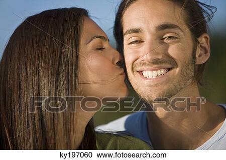Woman kissing a man View Large Photo Image Stock Image - Woman kissing a man. Fotosearch