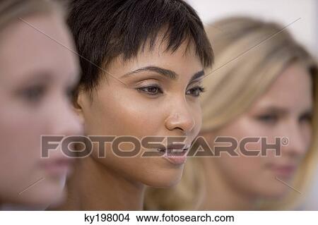 Close-up of three women looking serious View Large Photo Image Picture - Close-up of three women looking serious. Fotosearch