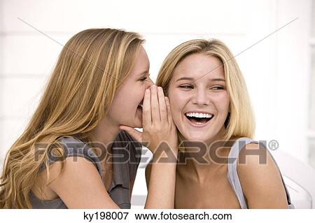 Close-up of two women gossiping View Large Photo Image Stock Photo - Close-up of two women gossiping. Fotosearch