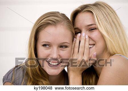 Stock Photo - Close-up of two women gossiping. Fotosearch