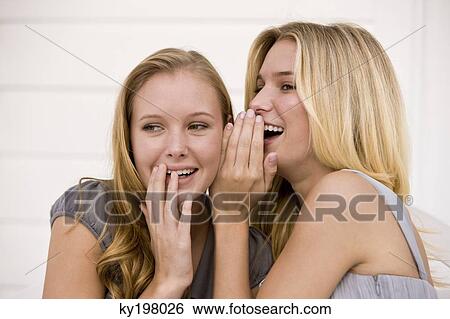 Close-up of two women gossiping View Large Photo Image Stock Photograph - Close-up of two women gossiping. Fotosearch
