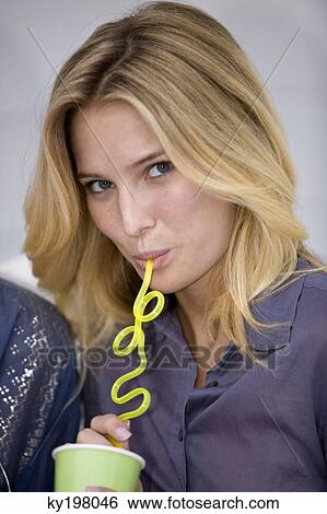Portrait of a woman drinking from a disposable cup View Large Photo Image Stock Photograph - Portrait of a woman drinking from a disposable cup. Fotosearch