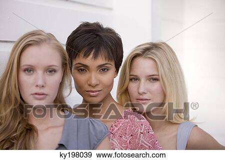Stock Photo - Portrait of three women posing. Fotosearch
