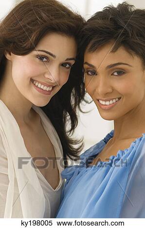 Stock Photography - Portrait of two female friends smiling. Fotosearch