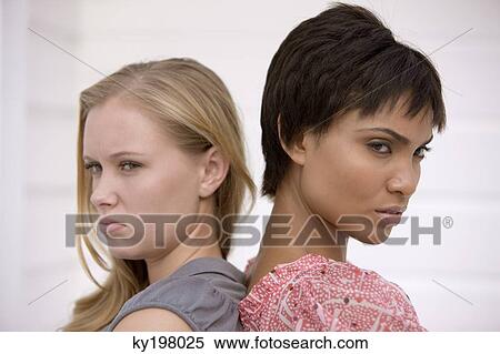 Portrait of two women looking displeased View Large Photo Image Stock Photography - Portrait of two women looking displeased. Fotosearch