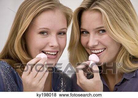 Two women eating mushroom shaped candies View Large Photo Image Stock Photo - Two women eating mushroom shaped candies. Fotosearch