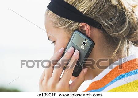 Close-up of a woman talking on a mobile phone View Large Photo Image Stock Photo - Close-up of a woman talking on a mobile phone. Fotosearch
