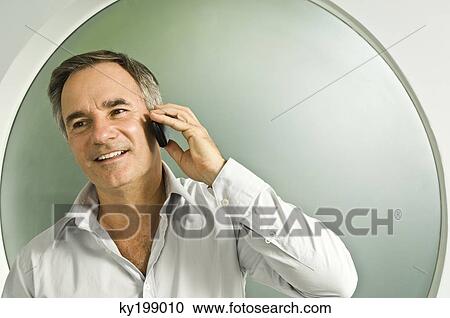 Man talking on a mobile phone View Large Photo Image Stock Image - Man talking on a mobile phone. Fotosearch