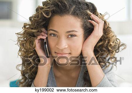 Portrait of a girl talking on a mobile phone View Large Photo Image Stock Image - Portrait of a girl talking on a mobile phone. Fotosearch