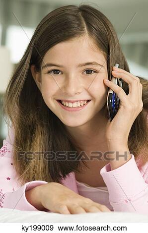 Stock Photo - Portrait of a girl talking on a mobile phone. Fotosearch