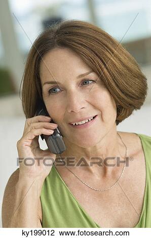 Stock Image - Woman talking on a mobile phone. Fotosearch