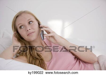 Woman talking on a mobile phone View Large Photo Image Stock Image - Woman talking on a mobile phone. Fotosearch