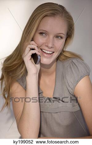 Woman talking on a mobile phone View Large Photo Image Stock Image - Woman talking on a mobile phone. Fotosearch