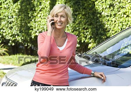 Woman talking on a mobile phone View Large Photo Image Stock Photo - Woman talking on a mobile phone. Fotosearch
