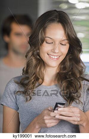 Woman text messaging on a mobile phone View Large Photo Image Stock Image - Woman text messaging on a mobile phone. Fotosearch